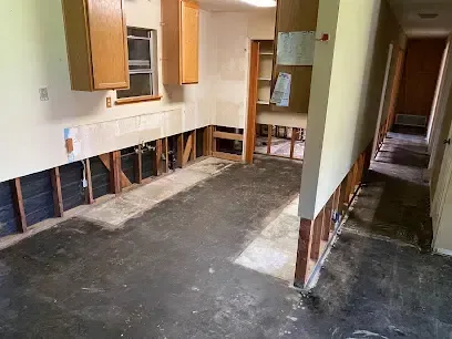 Flood cut along the lower drywall of a kitchen and hallway so the wall cavity can dry
