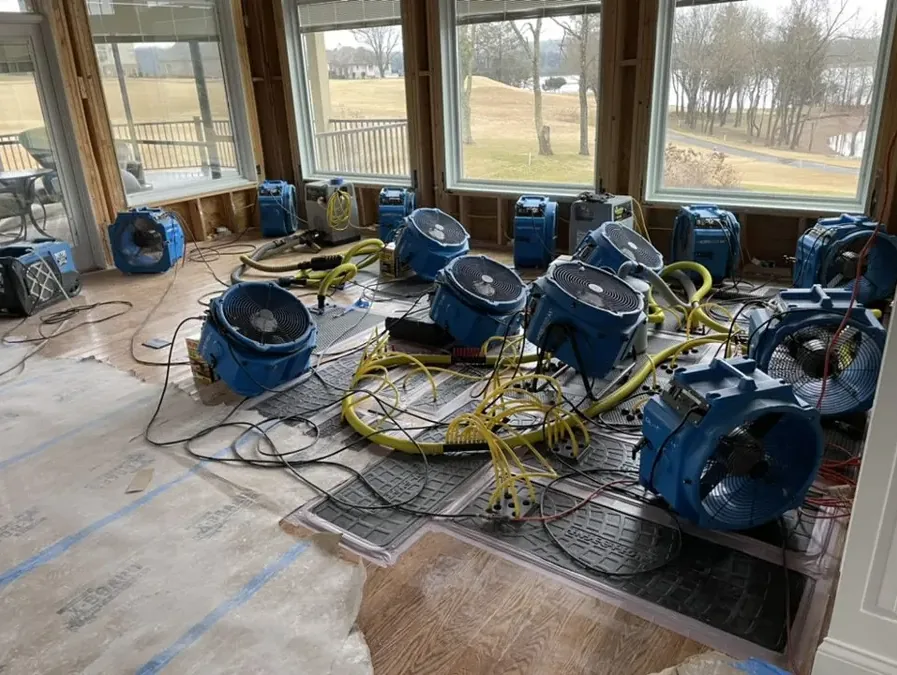 Drying equipment set up inside a home after a water loss, running until the readings come down